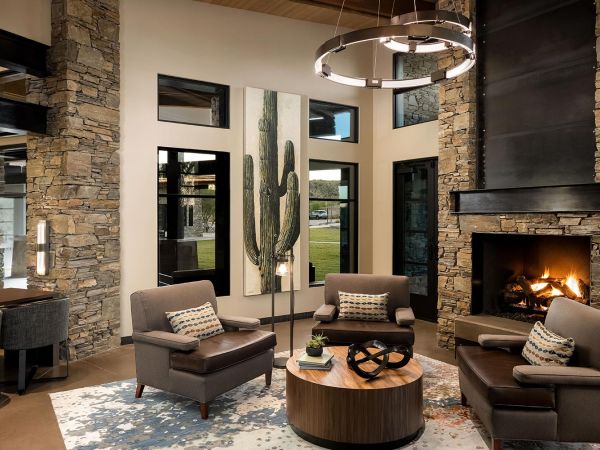 Living room with fireplace and stone wall